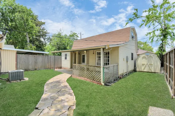 a view of a house with a yard and a garden