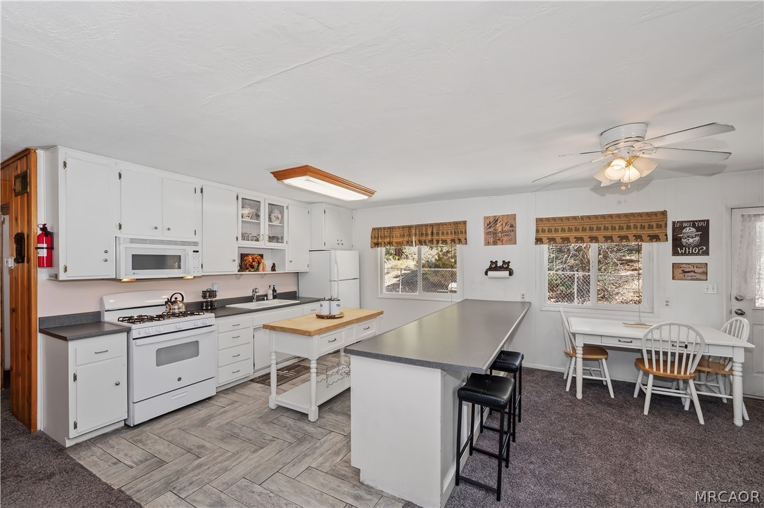 1099 Canyon Road Fawnskin, CA 92333 - Photo 11 of 39 a kitchen with a table and chairs in it