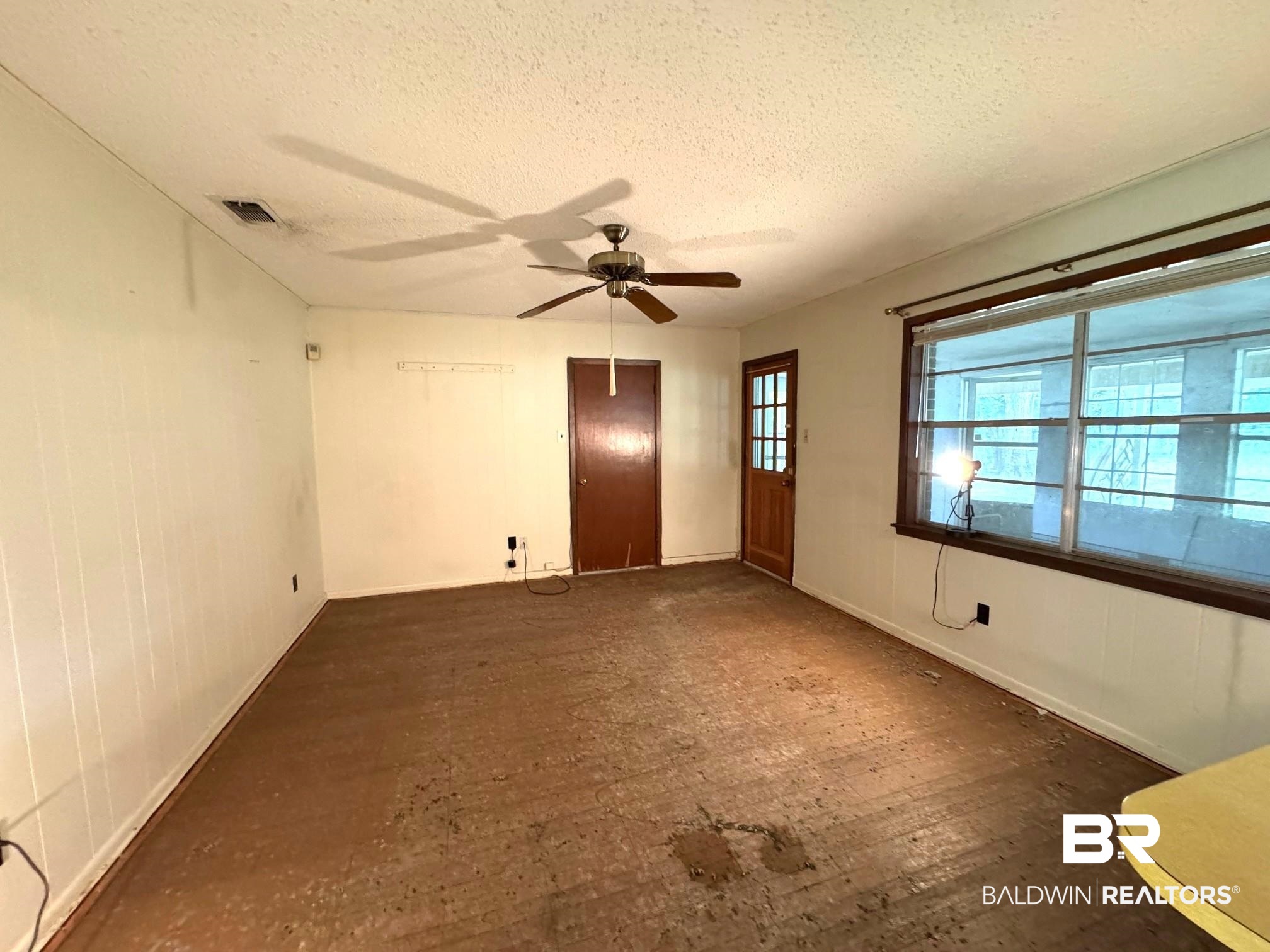 5198 Lancelot Drive Mobile, AL 36619 - Photo 8 of 30 Spare room with a textured ceiling, ceiling fan, and wood finished floors