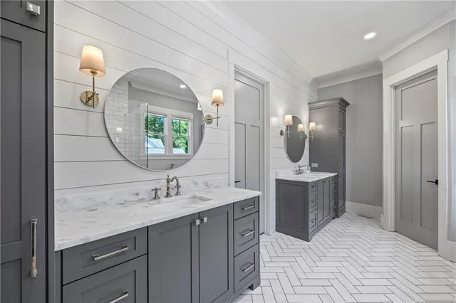 a bathroom with a granite countertop sink a toilet and shower