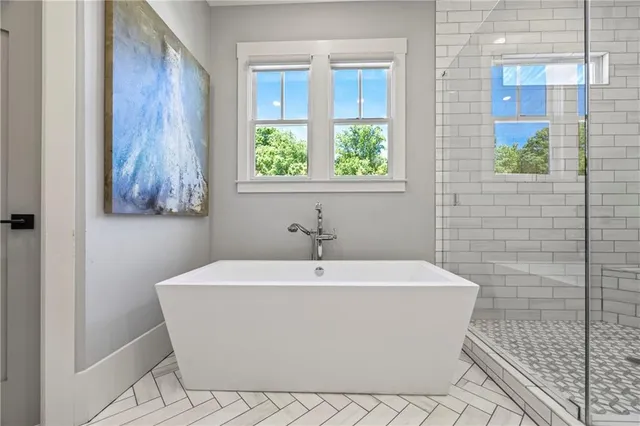 a bathroom with a shower a sink and mirror