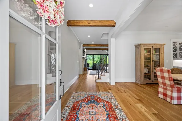a view of a hallway to a livingroom with furniture