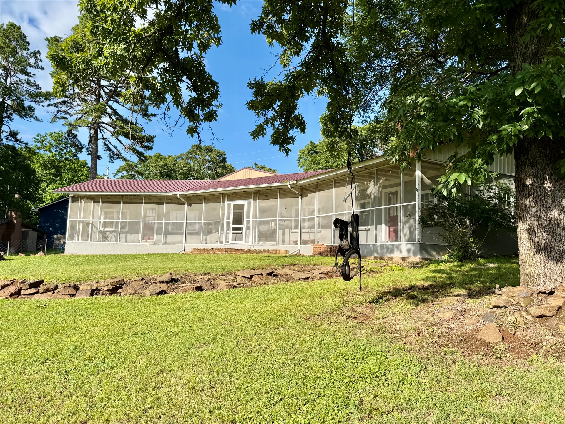 19442 West 929th Cookson, OK 74427 - Photo 1 of 26 Expansive screened-in porch with multiple entry points, featuring a durable metal roof and a concrete foundation