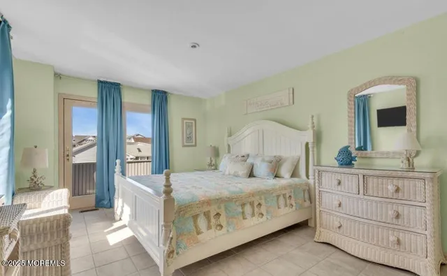 a bedroom with a large bed and a dresser