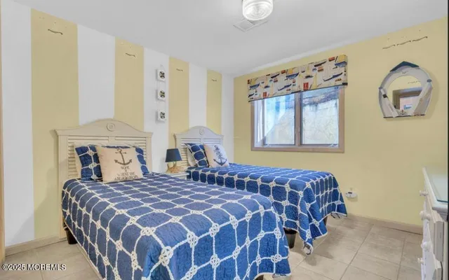 a bedroom with double bed and two windows