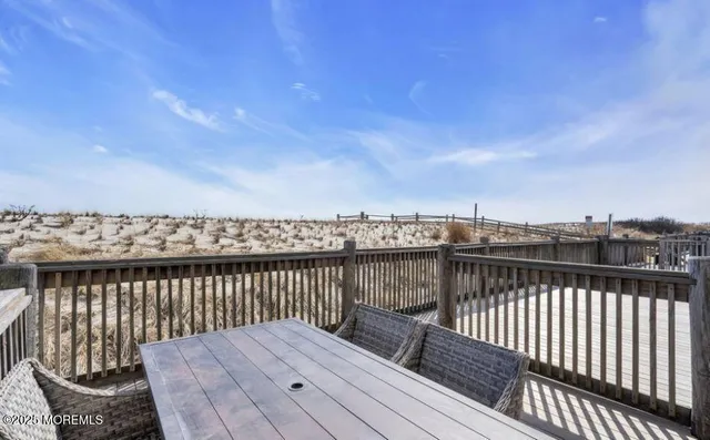 a view of a roof deck with wooden floor and fence