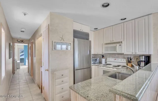 a kitchen that has a lot of cabinets in it and appliances