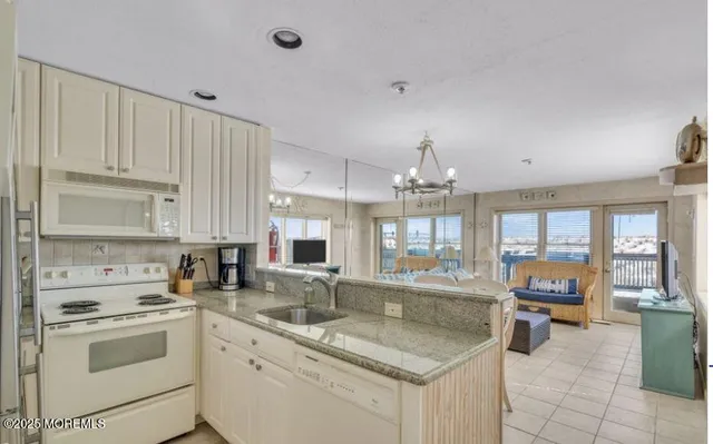 a kitchen with stainless steel appliances granite countertop a stove refrigerator and cabinets