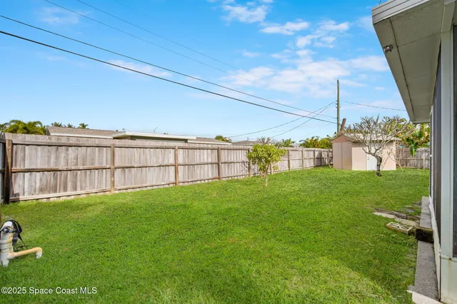 a view of a backyard with grass