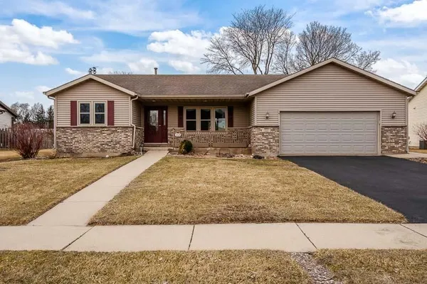 a front view of a house with yard and garage
