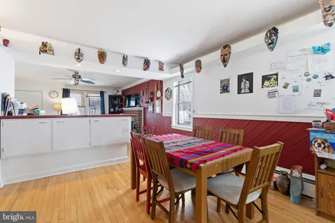 a dining room with a wooden table and chairs