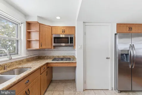 a kitchen with a refrigerator sink and stove