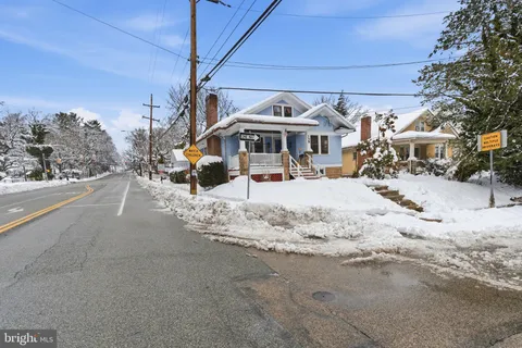 a view of a house with snow on the road