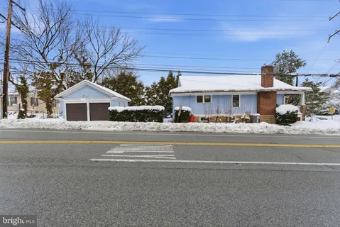 a front view of a house with a garden and plants