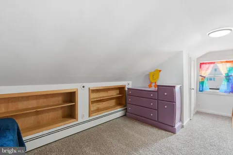 a bedroom with a bed and a bookshelf
