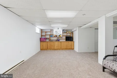 a bed room with a bed a white couch and a window