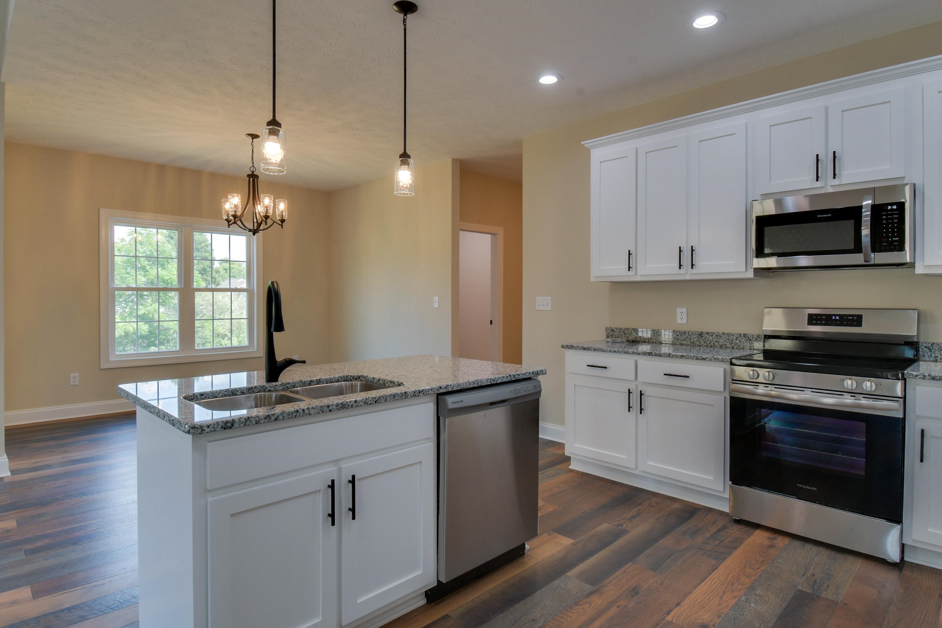103 Fall Ridge Drive Stuarts Draft, VA 24477 - Photo 11 of 31 a kitchen with kitchen island granite countertop stainless steel appliances a stove sink microwave and cabinets