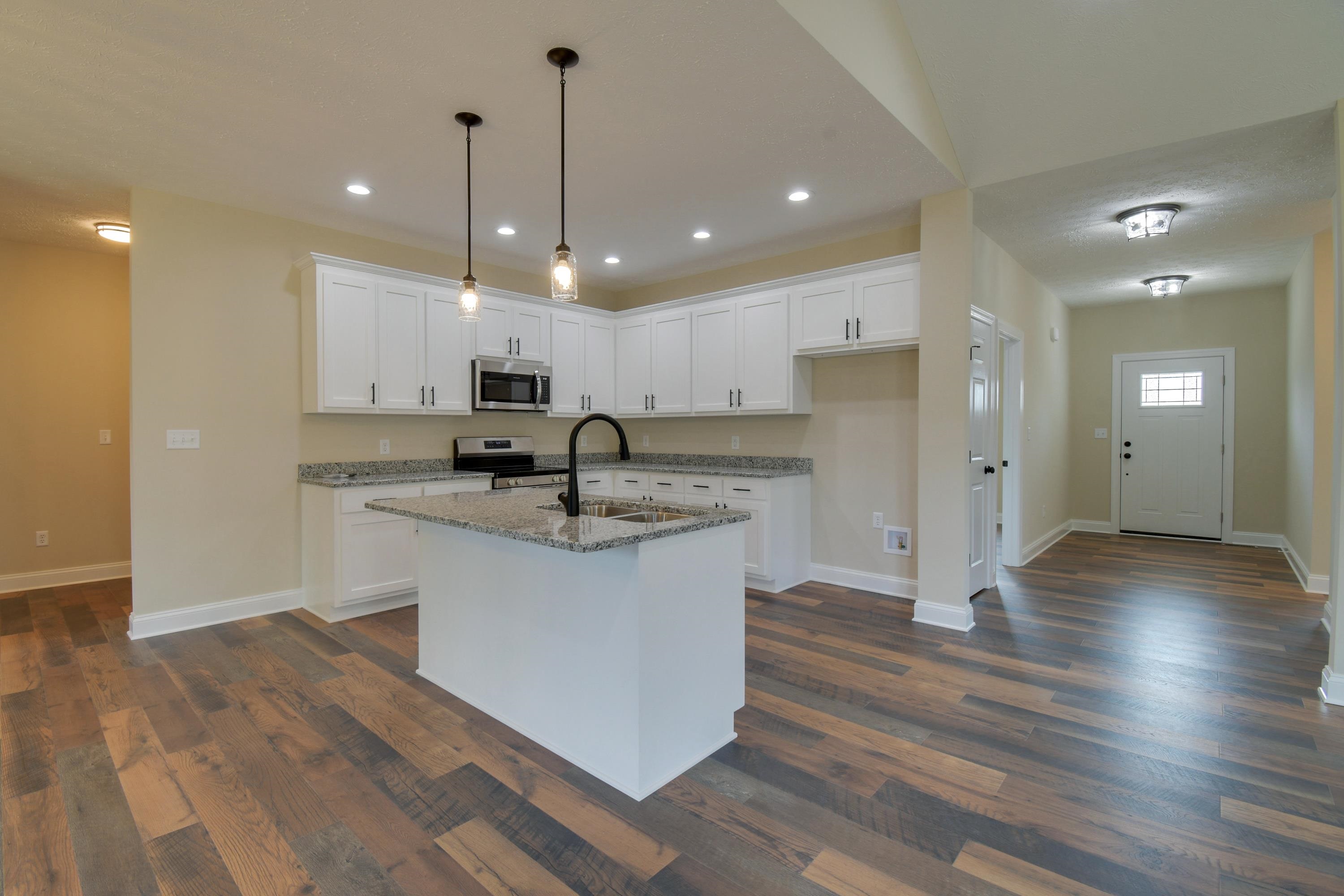 103 Fall Ridge Drive Stuarts Draft, VA 24477 - Photo 12 of 31 a kitchen with stainless steel appliances granite countertop a sink a stove a refrigerator and white cabinets with wooden floor