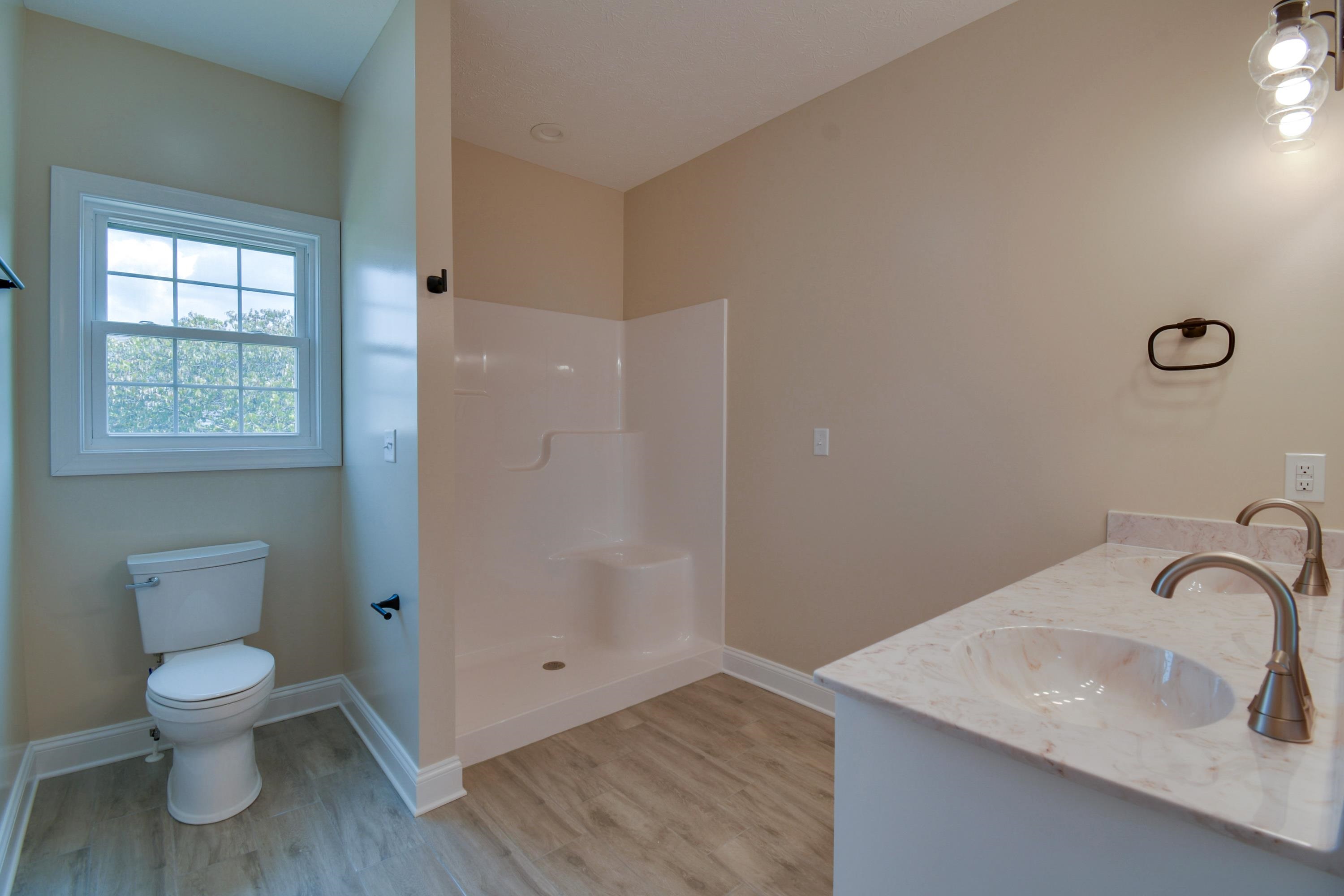 103 Fall Ridge Drive Stuarts Draft, VA 24477 - Photo 16 of 31 a bathroom with a toilet sink a mirror and shower