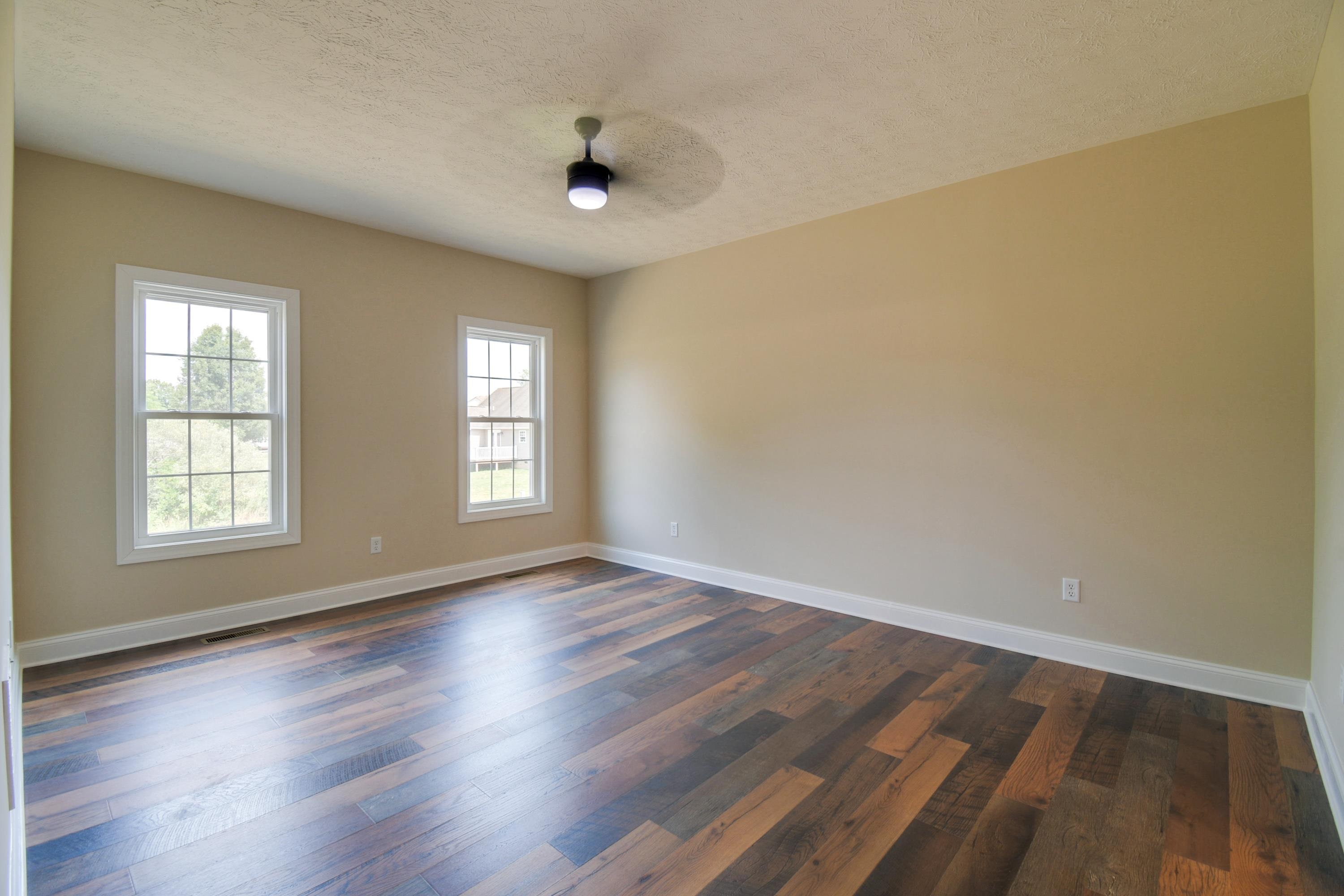 103 Fall Ridge Drive Stuarts Draft, VA 24477 - Photo 21 of 31 an empty room with wooden floor and windows