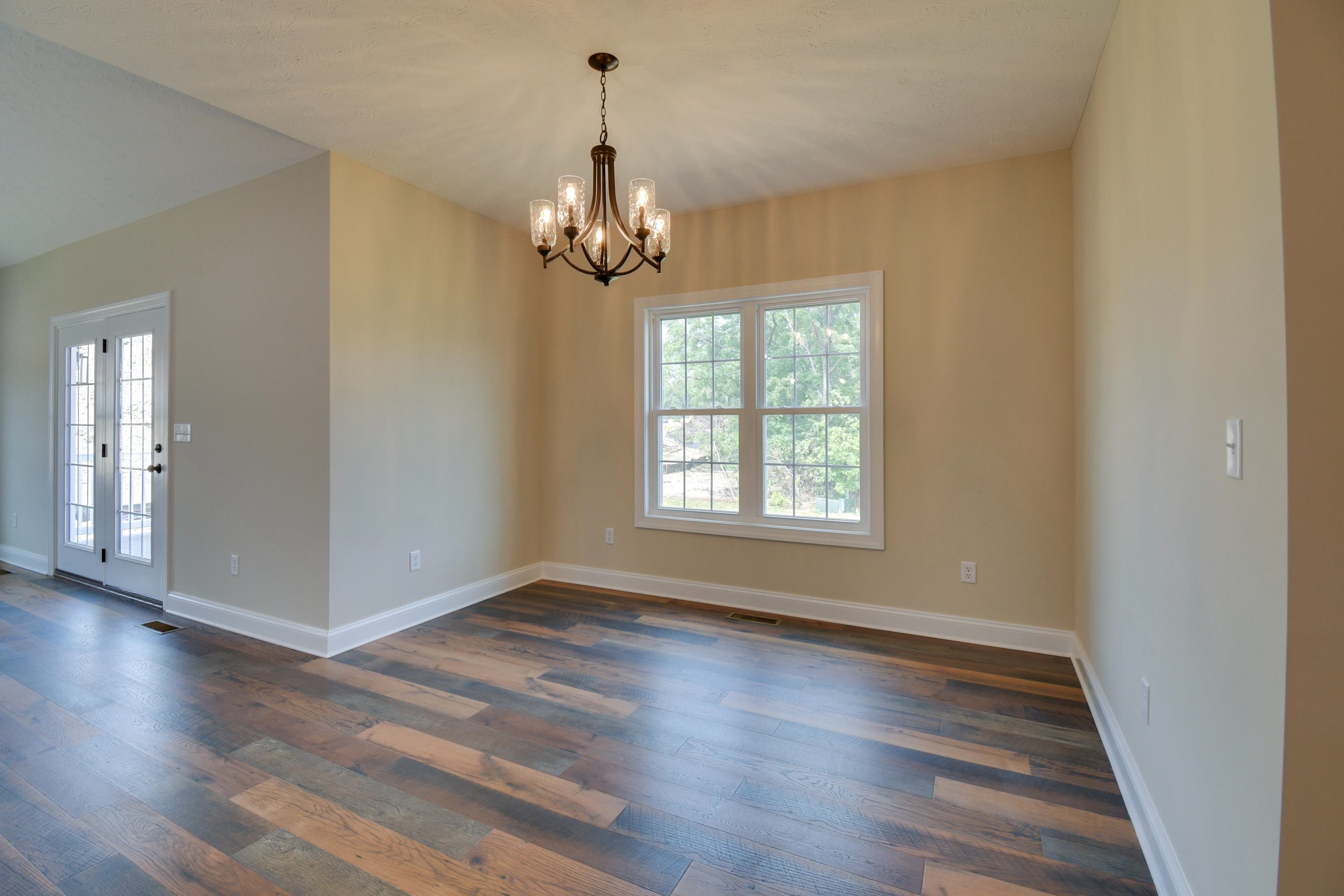 103 Fall Ridge Drive Stuarts Draft, VA 24477 - Photo 22 of 31 an empty room with wooden floor chandelier and windows