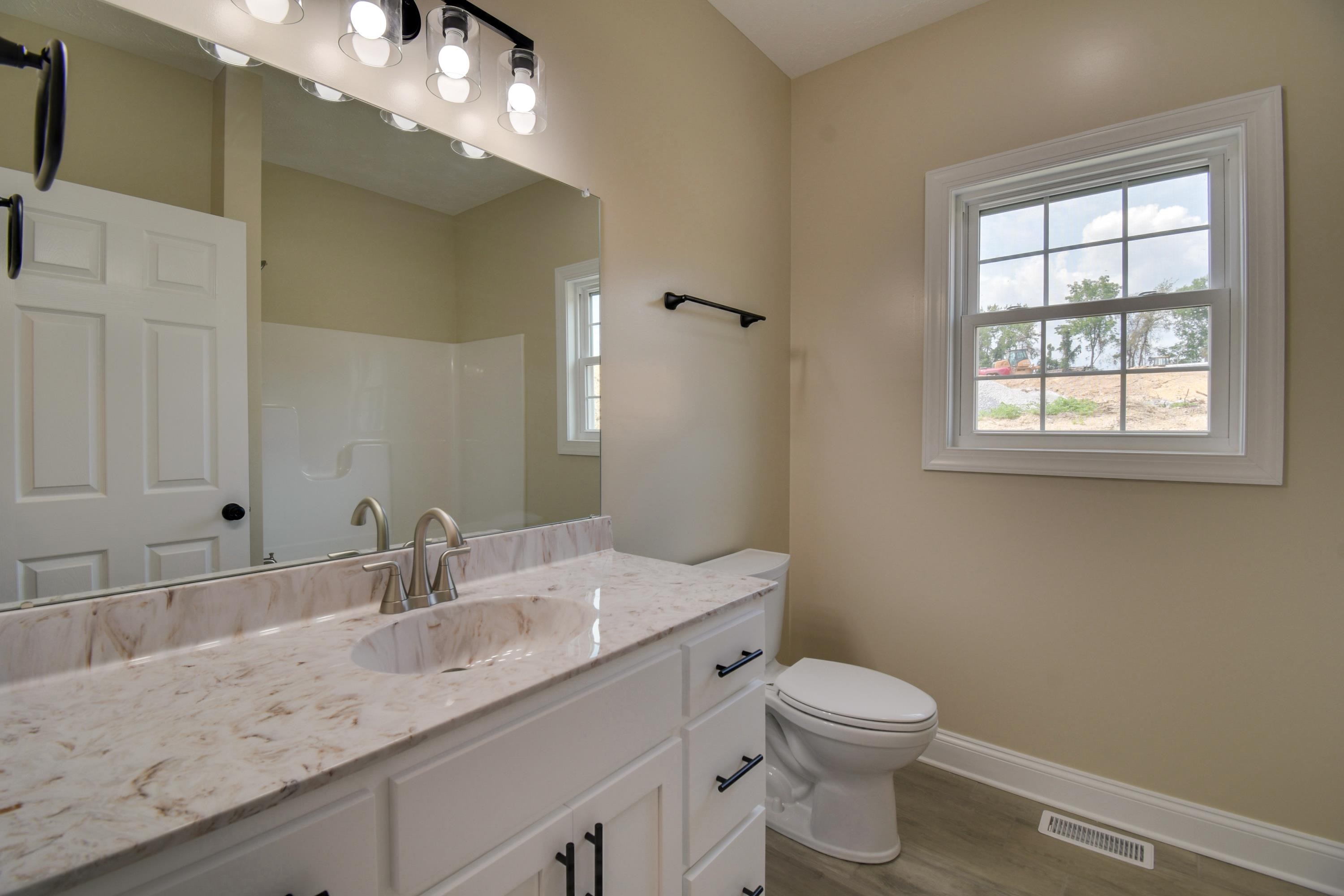 103 Fall Ridge Drive Stuarts Draft, VA 24477 - Photo 24 of 31 a bathroom with a granite countertop sink a toilet and a mirror