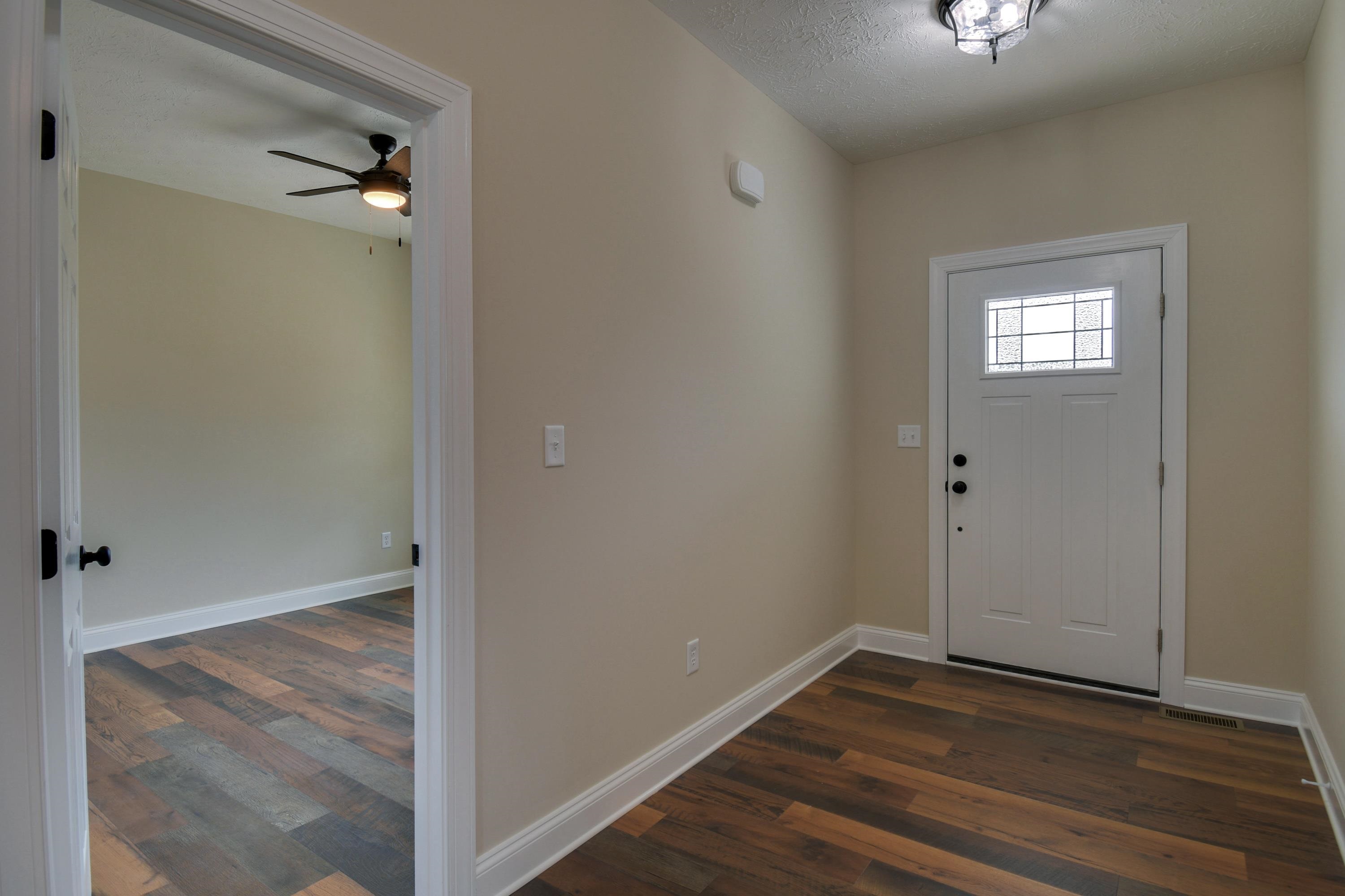103 Fall Ridge Drive Stuarts Draft, VA 24477 - Photo 30 of 31 a view of an empty room with wooden floor and a mirror
