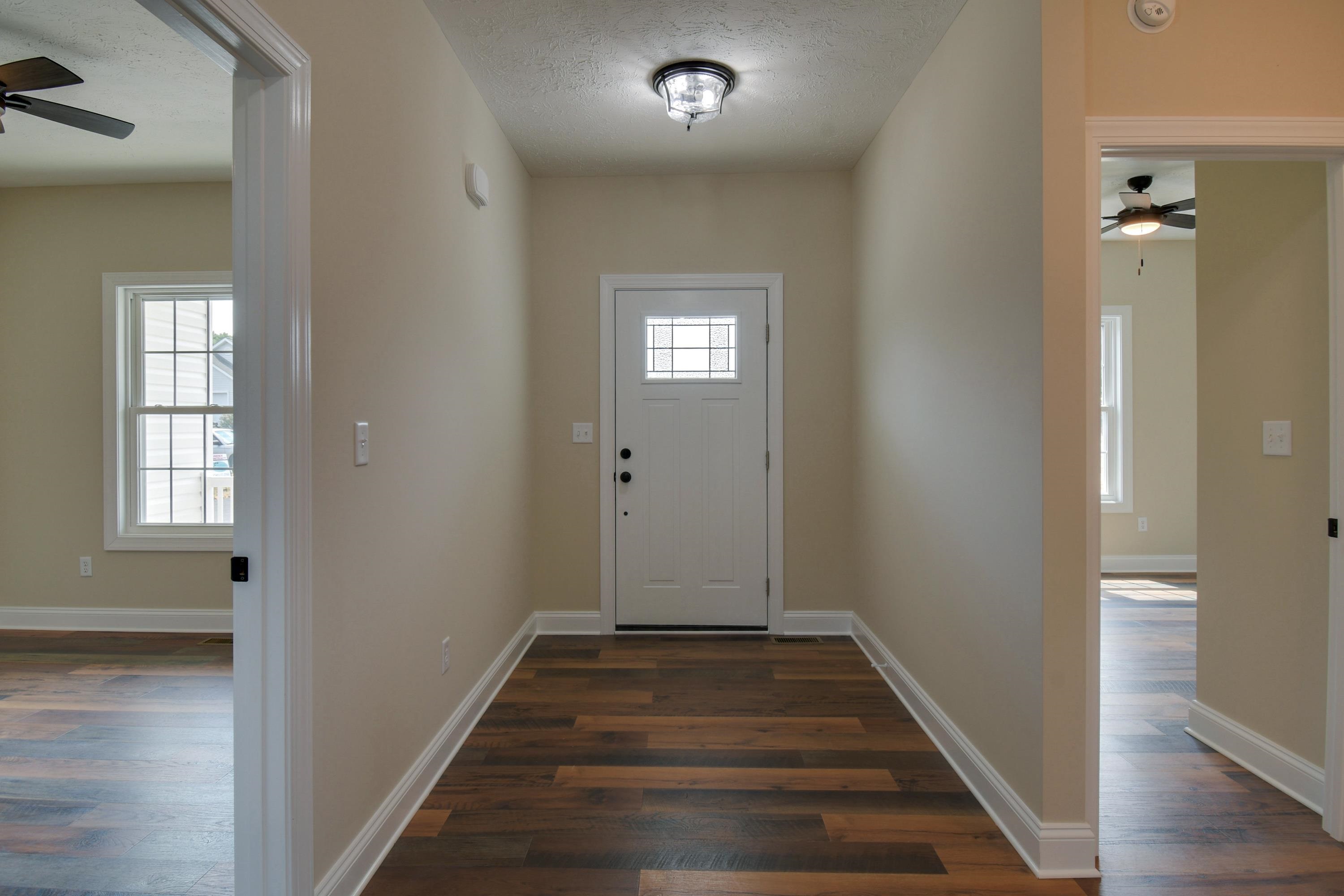 103 Fall Ridge Drive Stuarts Draft, VA 24477 - Photo 7 of 31 a view of a hallway with wooden floor and a bathroom
