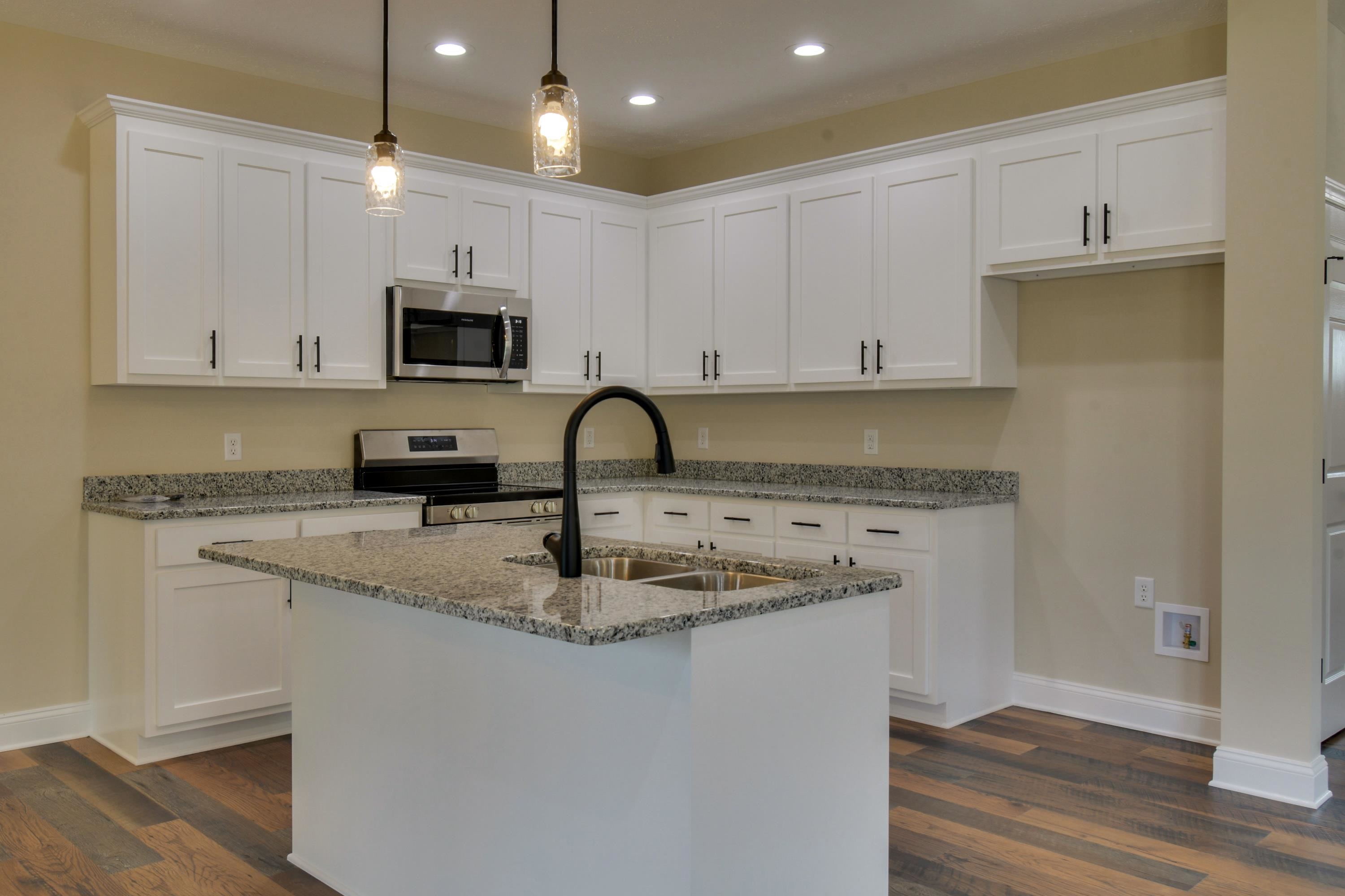 103 Fall Ridge Drive Stuarts Draft, VA 24477 - Photo 9 of 31 a kitchen with stainless steel appliances granite countertop a sink a stove a microwave a sink and white cabinets