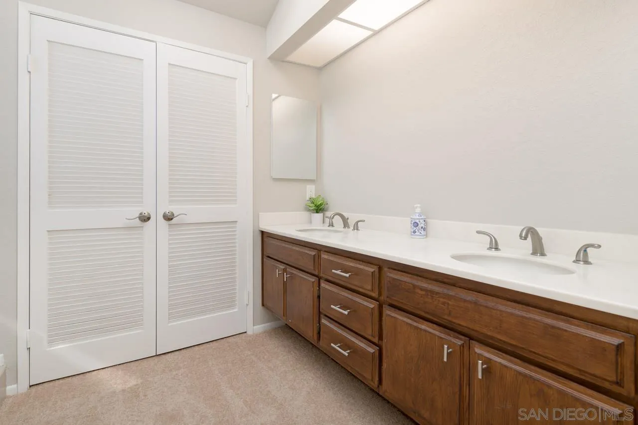1908 Hummock Lane Encinitas, CA 92024 - Photo 26 of 29 a bathroom with a double vanity sink and a mirror