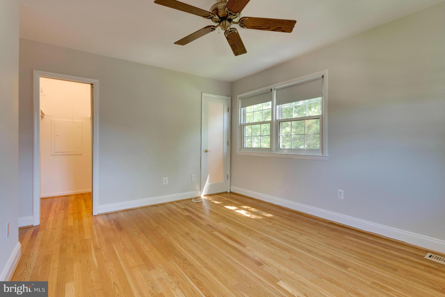 6003 Meriwether Lane Springfield, VA 22150 - Photo 13 of 30 a view of an empty room with wooden floor and a window