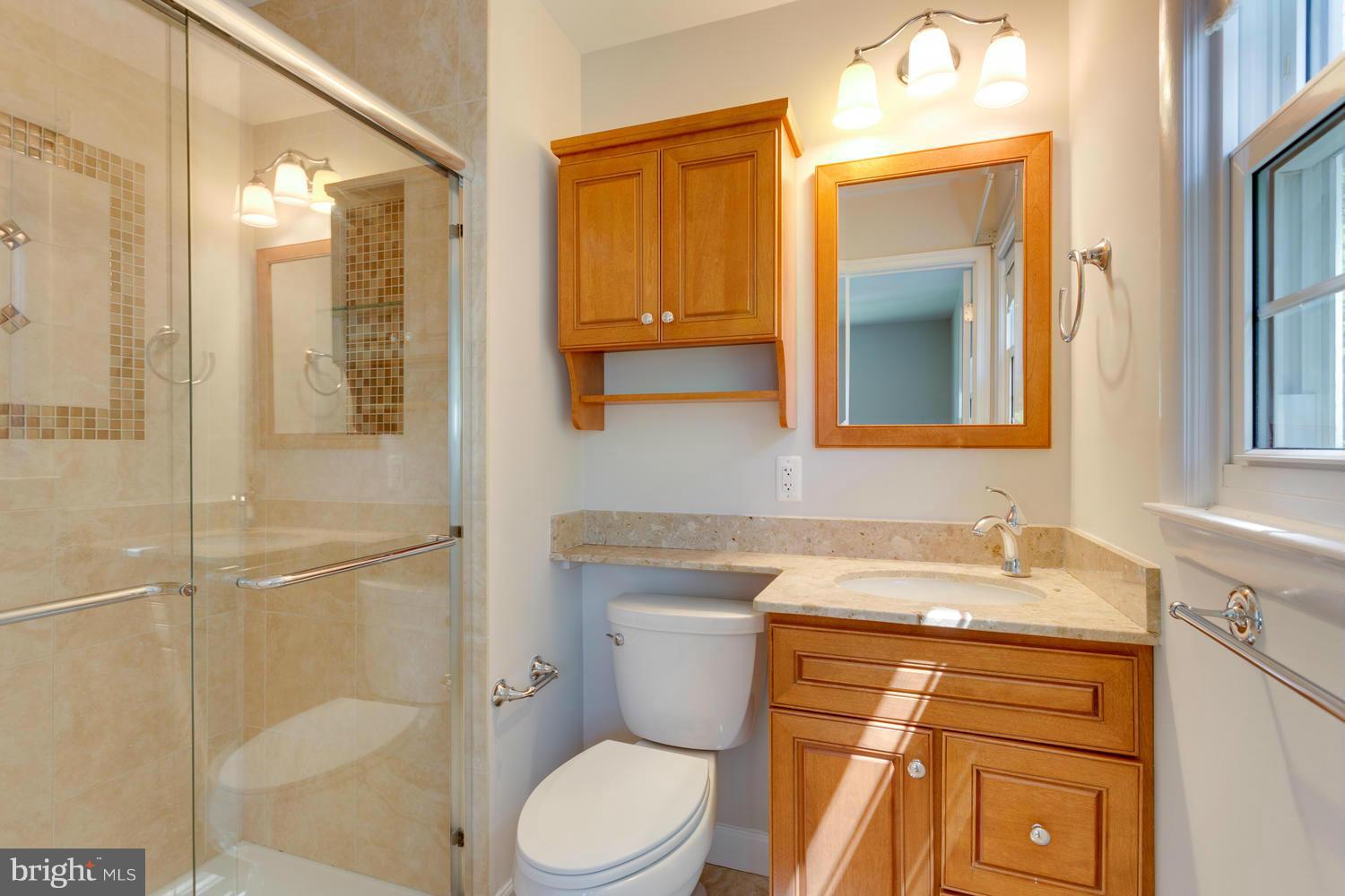 6003 Meriwether Lane Springfield, VA 22150 - Photo 14 of 30 a bathroom with a sink a toilet and shower