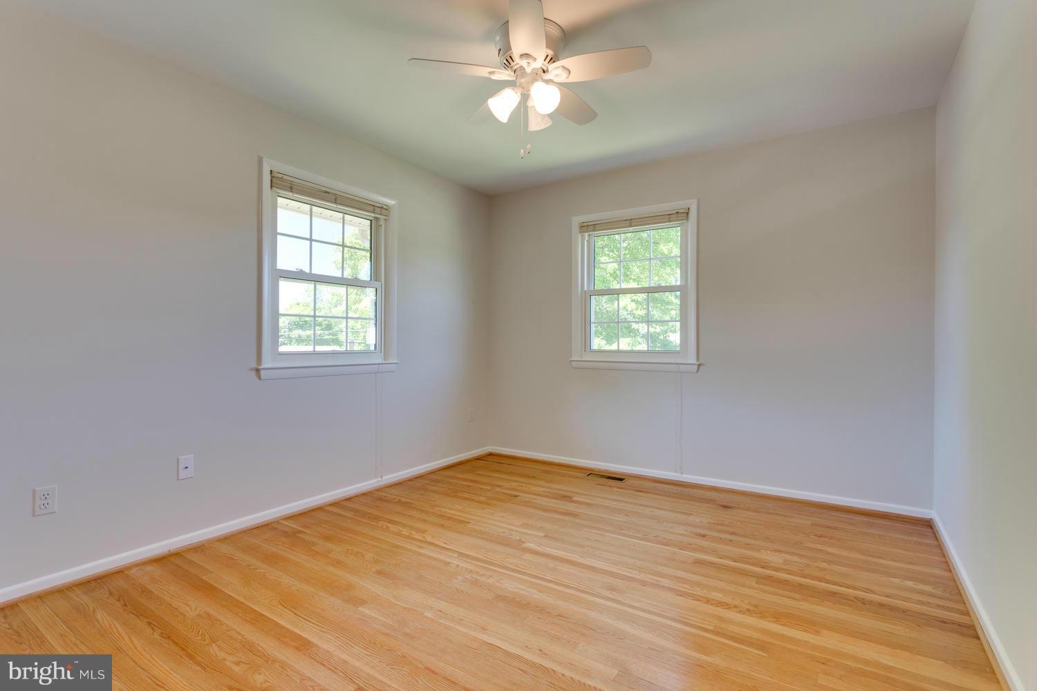 6003 Meriwether Lane Springfield, VA 22150 - Photo 16 of 30 a view of empty room with wooden floor and fan