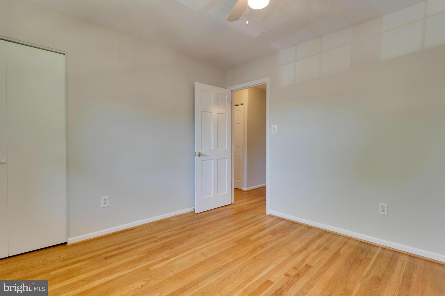 6003 Meriwether Lane Springfield, VA 22150 - Photo 19 of 30 a view of an empty room and wooden floor