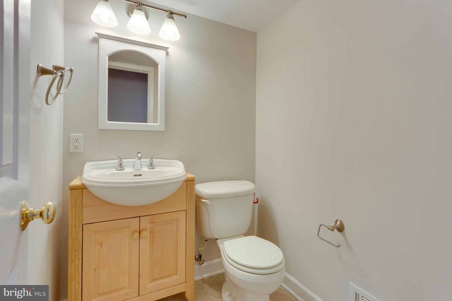 6003 Meriwether Lane Springfield, VA 22150 - Photo 25 of 30 a bathroom with a sink a toilet and mirror