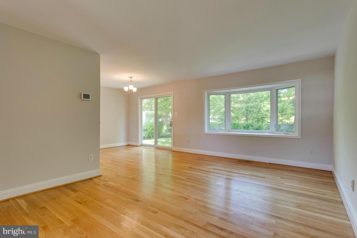 6003 Meriwether Lane Springfield, VA 22150 - Photo 4 of 30 an empty room with wooden floor and windows
