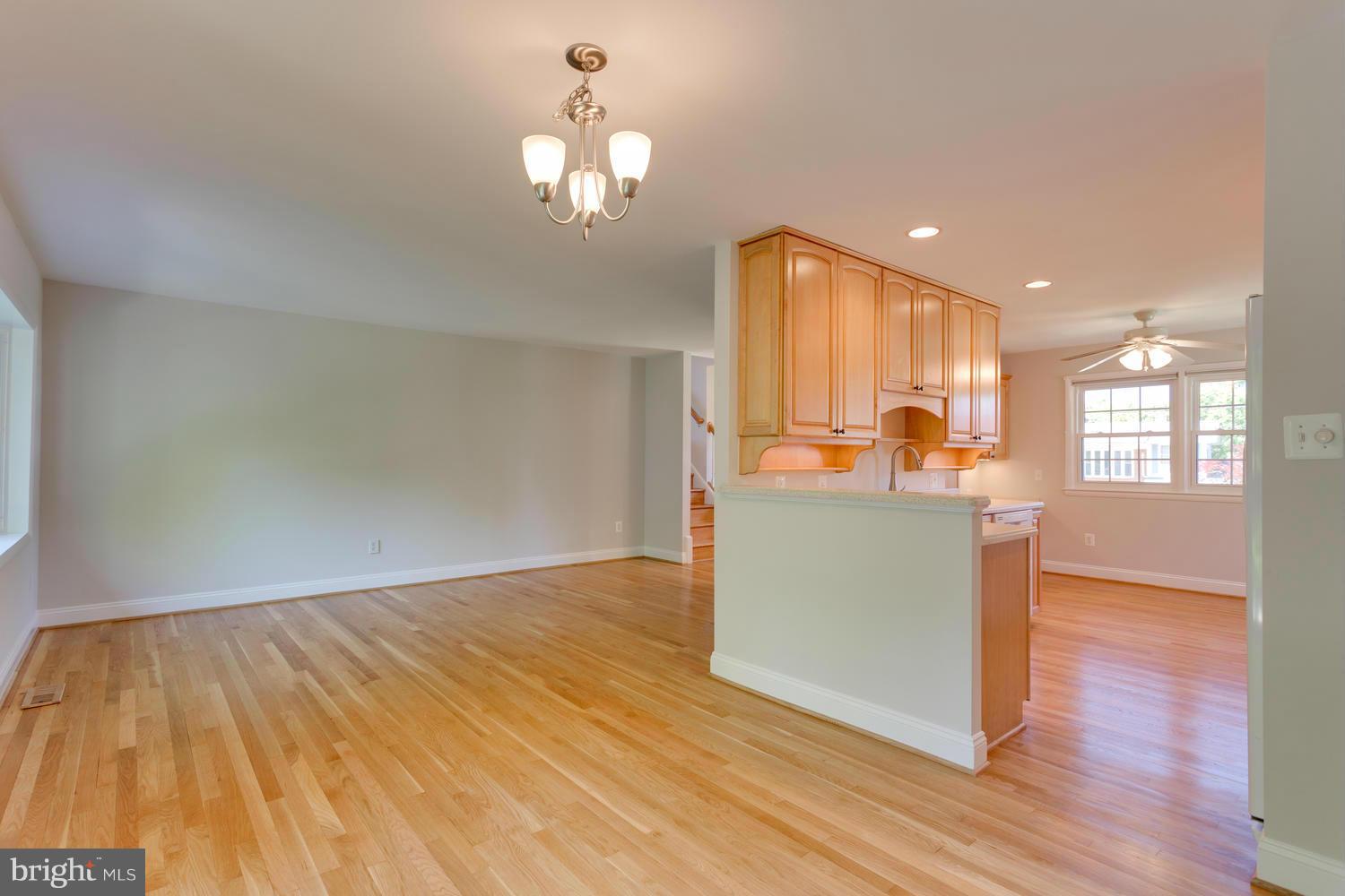 6003 Meriwether Lane Springfield, VA 22150 - Photo 7 of 30 a view of a room with wooden floor and kitchen view