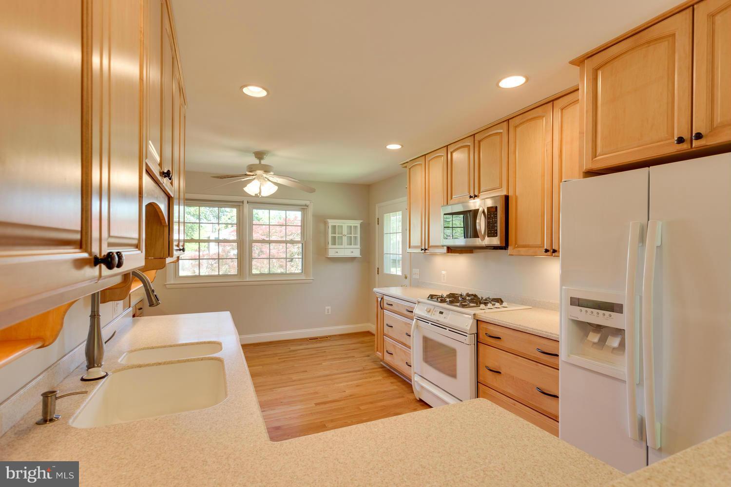 6003 Meriwether Lane Springfield, VA 22150 - Photo 8 of 30 a kitchen with stainless steel appliances granite countertop a stove a sink and a refrigerator