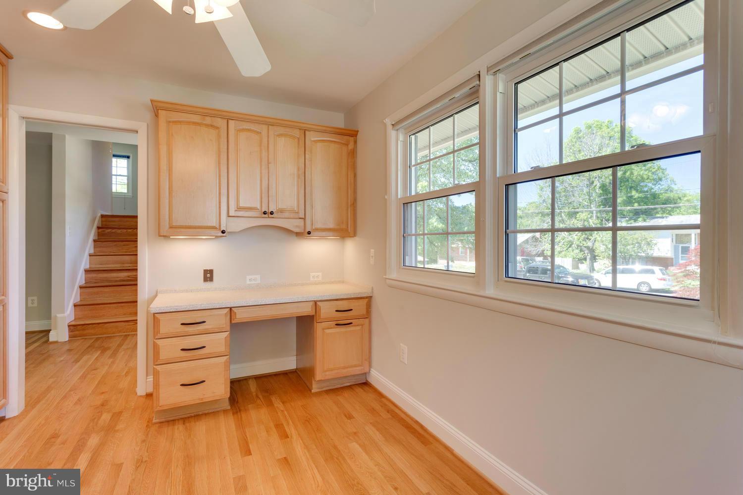6003 Meriwether Lane Springfield, VA 22150 - Photo 10 of 30 a kitchen with stainless steel appliances granite countertop a dishwasher a stove and a wooden floor