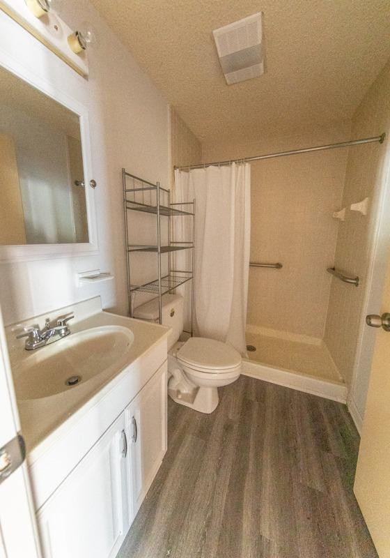 3007 Emory Street Lubbock, TX 79415 - Photo 4 of 17 a bathroom with a sink a toilet and shower