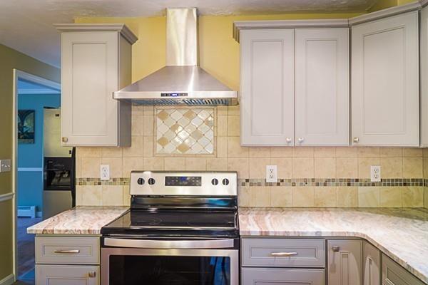 262 North Woodstock Road Southbridge, MA 01550 - Photo 6 of 25 a kitchen with granite countertop a stove a sink and a white cabinets