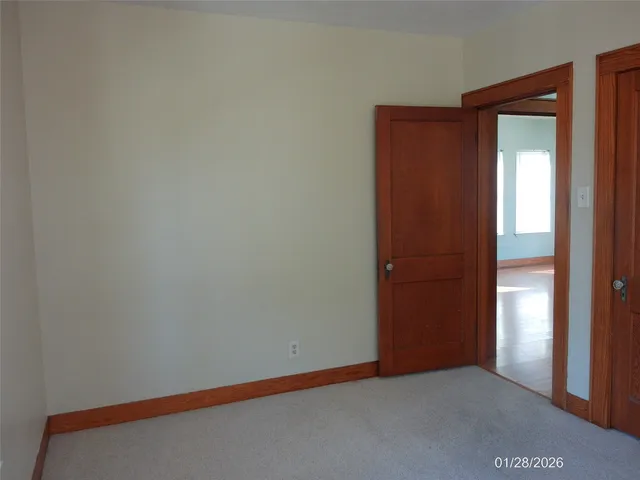 a view of an empty room and closet area