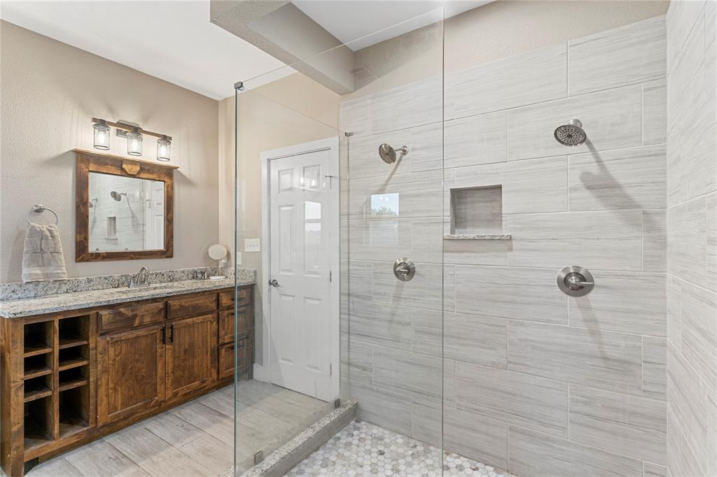 139 Kriston Lane Springtown, TX 76082 - Photo 26 of 39 Spacious walk-in shower with clear glass enclosure and dual showerheads