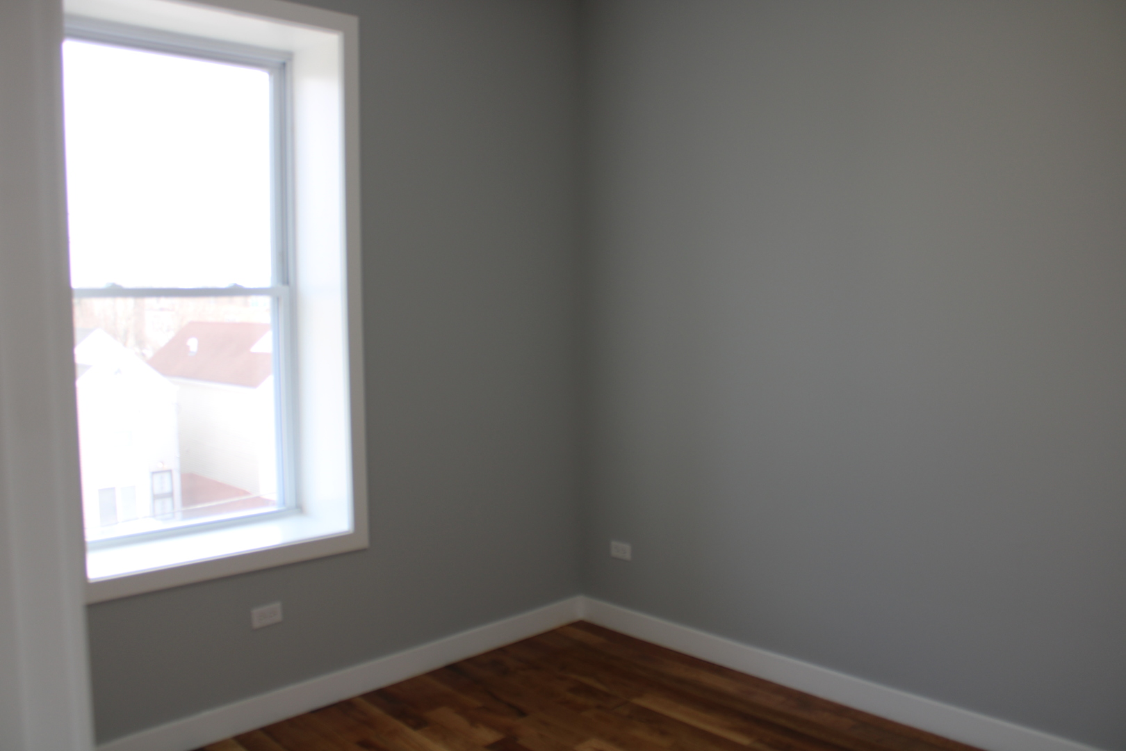 1533 South Ridgeway Avenue, Unit 1R Chicago, IL 60623 - Photo 5 of 7 an empty room with a window