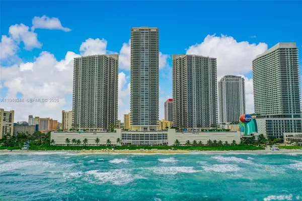 a view of a multi story building with a yard