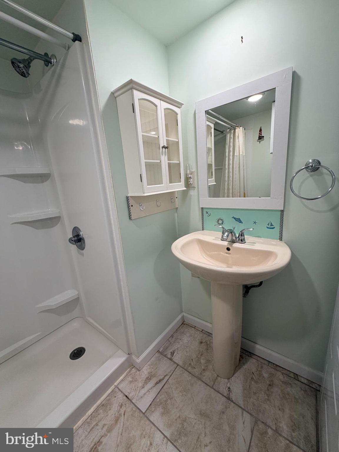 38019 Rabbit Road Ocean View, DE 19970 - Photo 23 of 51 a bathroom with a sink shower and a mirror