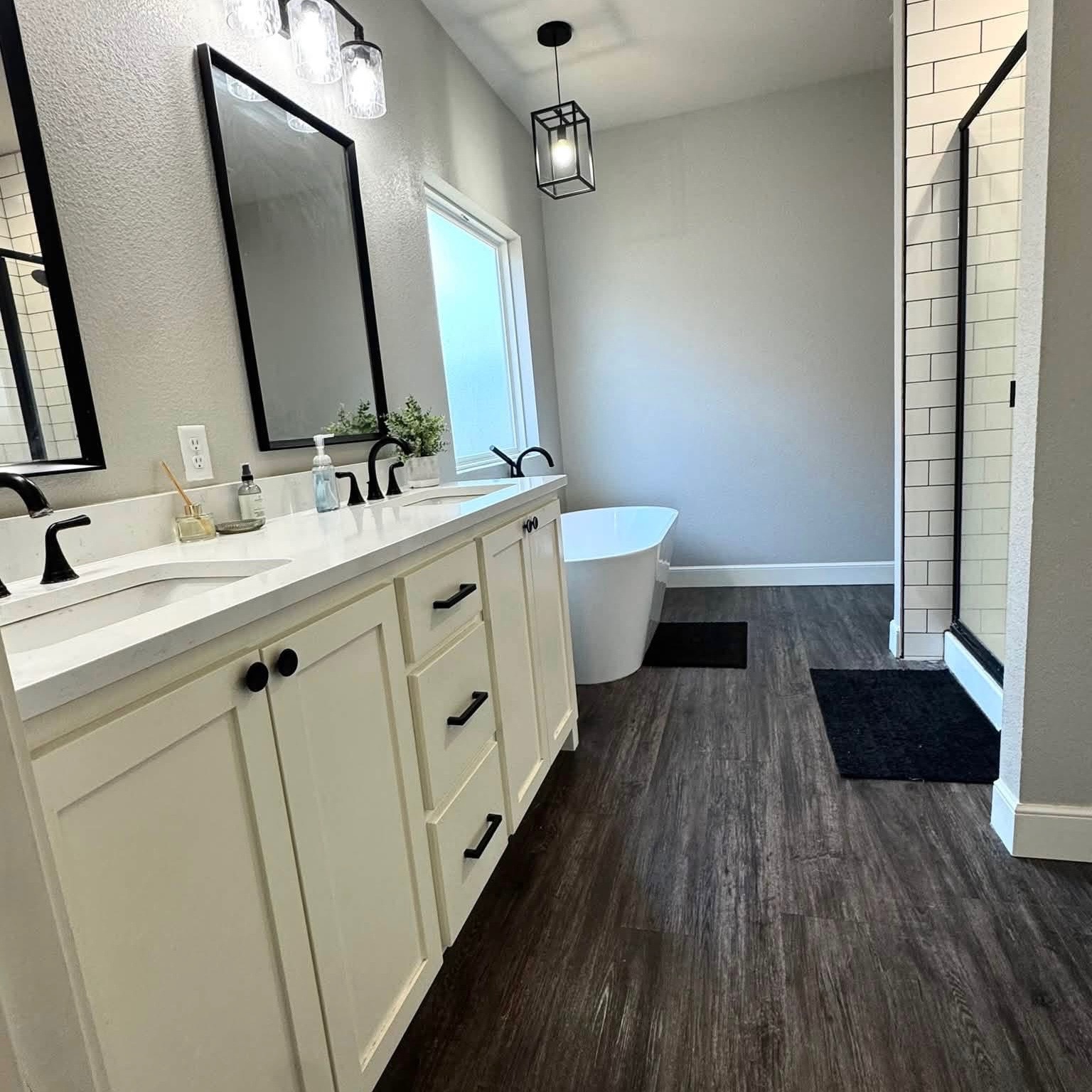 1114 Elkins Road Tuscola, TX 79562 - Photo 8 of 8 A freestanding soaking tub and dual vanity define this modern bathroom with wood-look flooring.