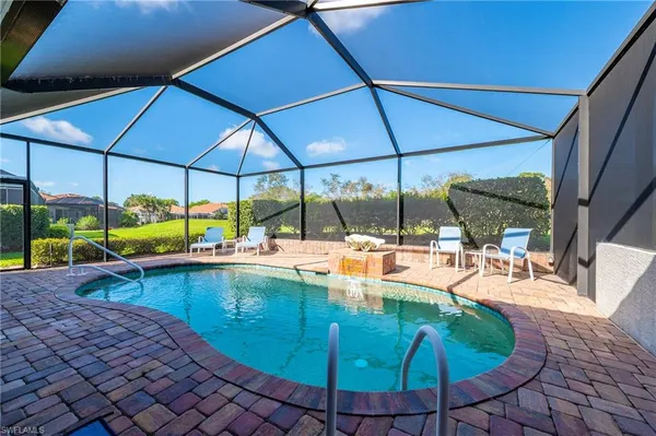 a view of a swimming pool with sitting area