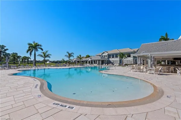a view of a house with swimming pool and sitting area