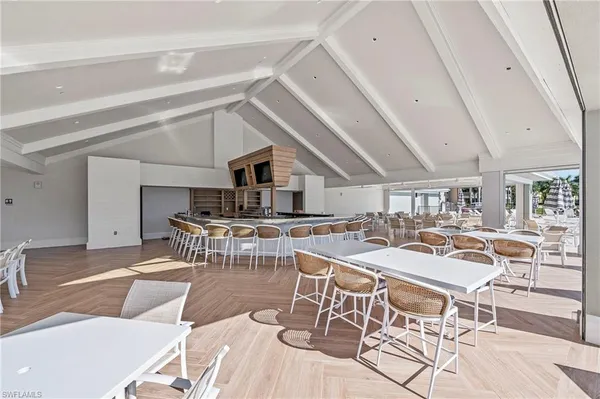 a view of a kitchen with furniture and wooden floor